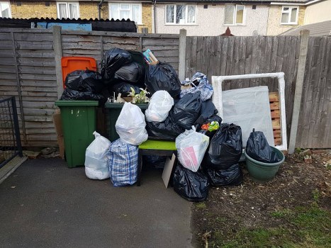 Cluttered garage before clearance in Hounslow