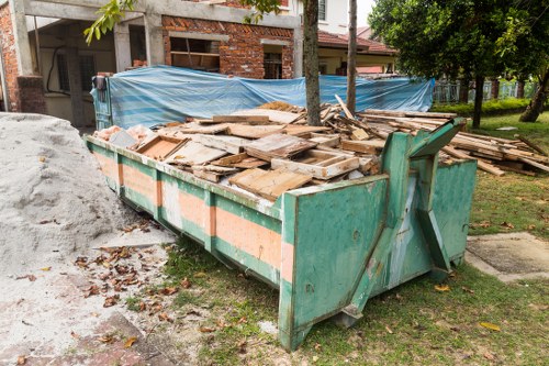 Bins labelled for paper, glass, organics and mixed recycling in a business yard
